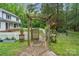 Brick pathway leads to a wooden arbor and fenced backyard at 15016 Rocky River Rd, Davidson, NC 28036