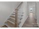 Modern staircase with gray railing and wood treads leading to the upper level at 280 Supernova Dr, York, SC 29745