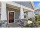 Front porch with stone detailing and a dark door at 280 Supernova Dr, York, SC 29745