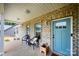 Covered front porch with seating and blue front door at 539 N C Ave, Maiden, NC 28650