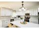 Bright kitchen featuring white cabinets, stainless steel appliances, and an island at 539 N C Ave, Maiden, NC 28650
