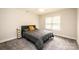 Cozy bedroom featuring a queen bed and large window with blinds at 539 N C Ave, Maiden, NC 28650
