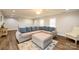 Living room featuring an L-shaped sofa, ottoman, and hardwood floors at 539 N C Ave, Maiden, NC 28650