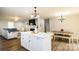 Island kitchen open to living and dining areas with white cabinets at 539 N C Ave, Maiden, NC 28650