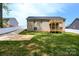Brick house with a two-tiered deck and grassy yard at 539 N C Ave, Maiden, NC 28650