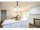 Open kitchen with white cabinets, island, and access to a deck at 539 N C Ave, Maiden, NC 28650