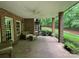 Brick patio with wicker furniture, ceiling fan, and wooded views at 500 Muirfield Dr, Albemarle, NC 28001