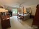Spacious bedroom with a four-poster bed, dresser, and ceiling fan at 500 Muirfield Dr, Albemarle, NC 28001