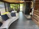 Relaxing screened porch with seating and wood flooring at 150 Marina Dr, New London, NC 28127