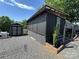 Property exterior with screened porch, shed, and landscaping at 150 Marina Dr, New London, NC 28127