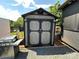 Gray and black storage shed with double doors at 150 Marina Dr, New London, NC 28127