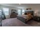 Bright bedroom with large bed, dresser, and neutral decor at 424 Wharton St, Monroe, NC 28110