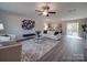 Spacious living room with hardwood floors, comfy seating, and large windows at 1016 Forest Dr, Marshville, NC 28103