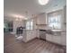 Updated kitchen featuring white shaker cabinets, stainless steel appliances and breakfast bar at 1016 Forest Dr, Marshville, NC 28103