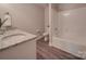 Bathroom with double vanity, shower, and white fixtures at 1016 Forest Dr, Marshville, NC 28103