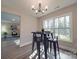 Dining area with black metal table and chairs, offering natural light and view to living room at 1016 Forest Dr, Marshville, NC 28103