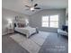 Spacious bedroom with a ceiling fan, large window, and stylish decor at 1016 Forest Dr, Marshville, NC 28103