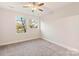 Charming bedroom with grey carpet and two windows at 1407 Collier Walk Aly # Csw0103, Charlotte, NC 28205