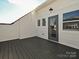 Private rooftop deck with composite decking and glass door access at 1217 E 34Th St # Csw0316, Charlotte, NC 28205