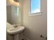 Small powder room with pedestal sink and octagon mirror at 1219 E 34Th St # Csw0317, Charlotte, NC 28205