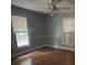 Simple bedroom with hardwood floors and two windows at 3130 Faith Rd, Salisbury, NC 28146
