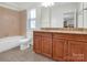 Well-appointed bathroom with double vanity and granite countertop at 509 Pine Needle Ct, Weddington, NC 28104