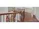 Upstairs hallway with hardwood floors and iron railings at 509 Pine Needle Ct, Weddington, NC 28104