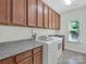 Laundry room with cabinets and granite countertop at 509 Pine Needle Ct, Weddington, NC 28104