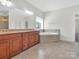 Bathroom features double vanity, granite countertop, and corner tub at 509 Pine Needle Ct, Weddington, NC 28104