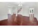 Open dining room with hardwood floors and views to the Gathering room and staircase at 509 Pine Needle Ct, Weddington, NC 28104