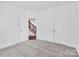 Bedroom with carpet, double doors, and access to stairs at 509 Pine Needle Ct, Weddington, NC 28104