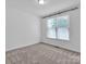 Bright bedroom with neutral walls, carpet, and window at 509 Pine Needle Ct, Weddington, NC 28104