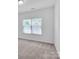 Well-lit bedroom with carpet and window coverings at 509 Pine Needle Ct, Weddington, NC 28104