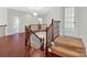 Upper level hallway with hardwood floors and open railing at 509 Pine Needle Ct, Weddington, NC 28104