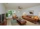 Open living room with brown leather sofa and hardwood floors at 271 Malvern Dr, Concord, NC 28025