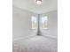 Bright bedroom with two windows and grey carpet at 2003 Cedar Falls Dr # 69, Waxhaw, NC 28173
