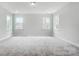 Bright bedroom with three windows and carpeting at 2003 Cedar Falls Dr # 69, Waxhaw, NC 28173