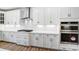 White kitchen features stainless steel appliances and hexagon tile backsplash at 2003 Cedar Falls Dr # 69, Waxhaw, NC 28173