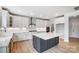 Modern kitchen with white cabinets, a large island, and stainless steel appliances at 2003 Cedar Falls Dr # 69, Waxhaw, NC 28173