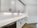 Built-in wet bar with white cabinets and quartz countertop at 2003 Cedar Falls Dr # 69, Waxhaw, NC 28173