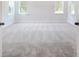 Bright bedroom with grey carpet and two large windows at 2004 Cedar Falls Dr # 4, Waxhaw, NC 28173