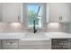 Kitchen features a farmhouse sink, white cabinets, and a view to the backyard at 2004 Cedar Falls Dr # 4, Waxhaw, NC 28173