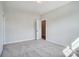Well-lit bedroom featuring carpet and access to another room at 2004 Cedar Falls Dr # 4, Waxhaw, NC 28173