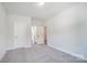 Bright bedroom with grey carpet, and doors leading to the bathroom and hallway at 2004 Cedar Falls Dr # 4, Waxhaw, NC 28173
