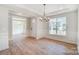 Bright dining room features a chandelier and hardwood floors at 2004 Cedar Falls Dr # 4, Waxhaw, NC 28173