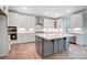 Modern kitchen with white cabinets and large island at 2004 Cedar Falls Dr # 4, Waxhaw, NC 28173
