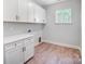 Laundry room with white cabinets and wood-look flooring at 2004 Cedar Falls Dr # 4, Waxhaw, NC 28173