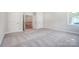 Upstairs bedroom with grey carpet and access to a hallway at 2004 Cedar Falls Dr # 4, Waxhaw, NC 28173