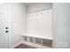 White entryway bench with storage and hooks at 2004 Cedar Falls Dr # 4, Waxhaw, NC 28173