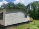 Side view of a manufactured home with wood deck at 7067 Citation St, York, SC 29745